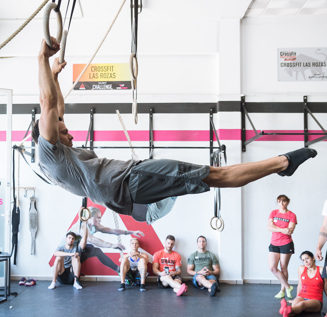 Dave Durante performing a ring swing in a Power Monkey Fitness Course.